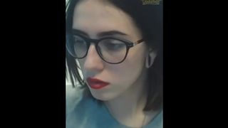 Cute Girl with Glasses Opens Mouth and Crosses Eyes
